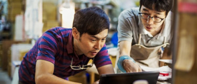 Colleagues collaborating over a laptop
