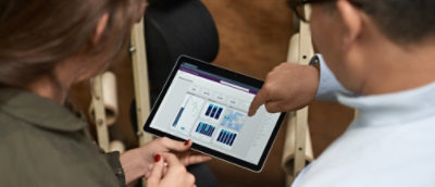 A close-up of a person holding a tablet.