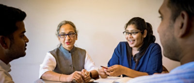Group discussion around table reviewing documents