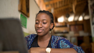 Person working on a laptop in a modern indoor workspace.