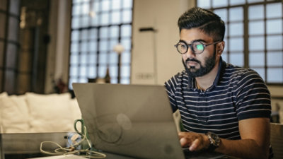 Person using a laptop at a café table.