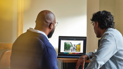 Two people watching a video together on a laptop