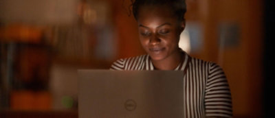 Person working on laptop at desk.