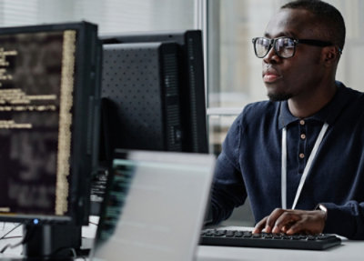 A person working on a computer with a screen displaying content.
