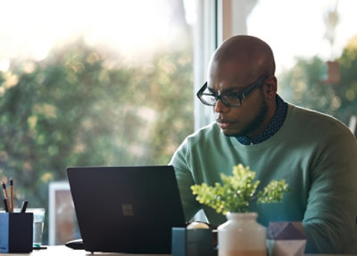 Person working on a laptop at a desk