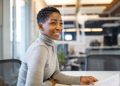 Person reviewing documents in an office setting.