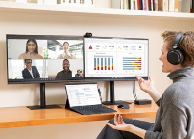 A woman wearing headphones and using a computer.