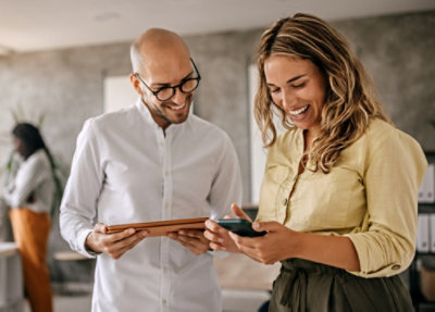 A woman sitting at a table using a laptop.