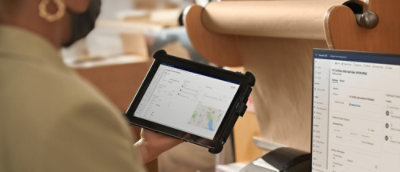 A person holding a tablet.