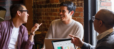 A woman and man discussing while looking at the laptop