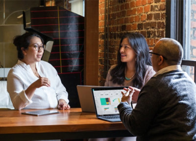 Team talking with laptop open