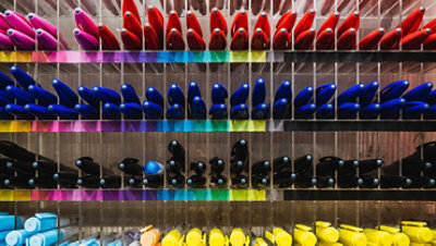 Collection of colorful pens on a shelf.