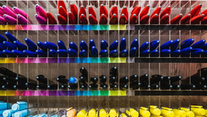 Collection of colorful pens on a shelf.