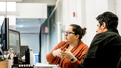 Two co-workers working together at a desk