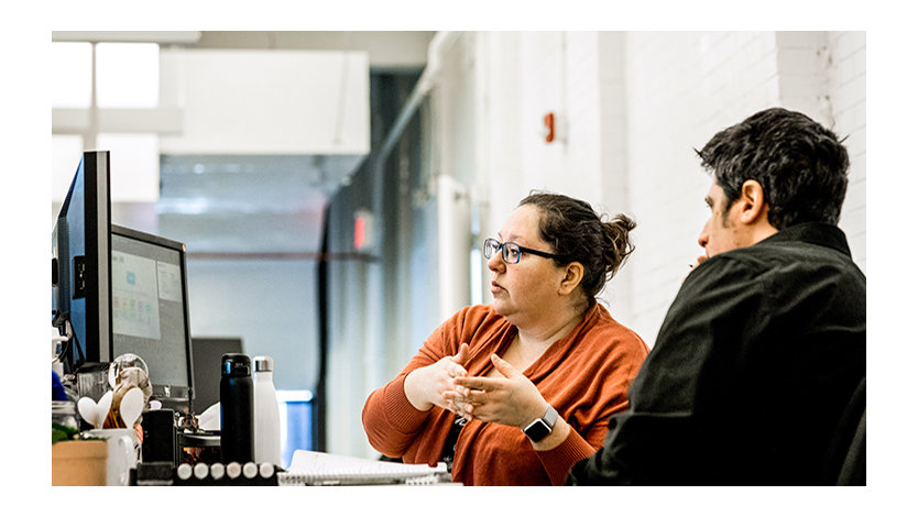 Two co-workers working together at a desk