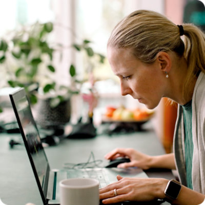 Female freelancer with a low vision working on laptop at home.