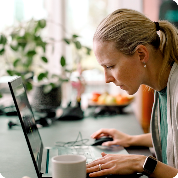 Female freelancer with a low vision working on laptop at home.