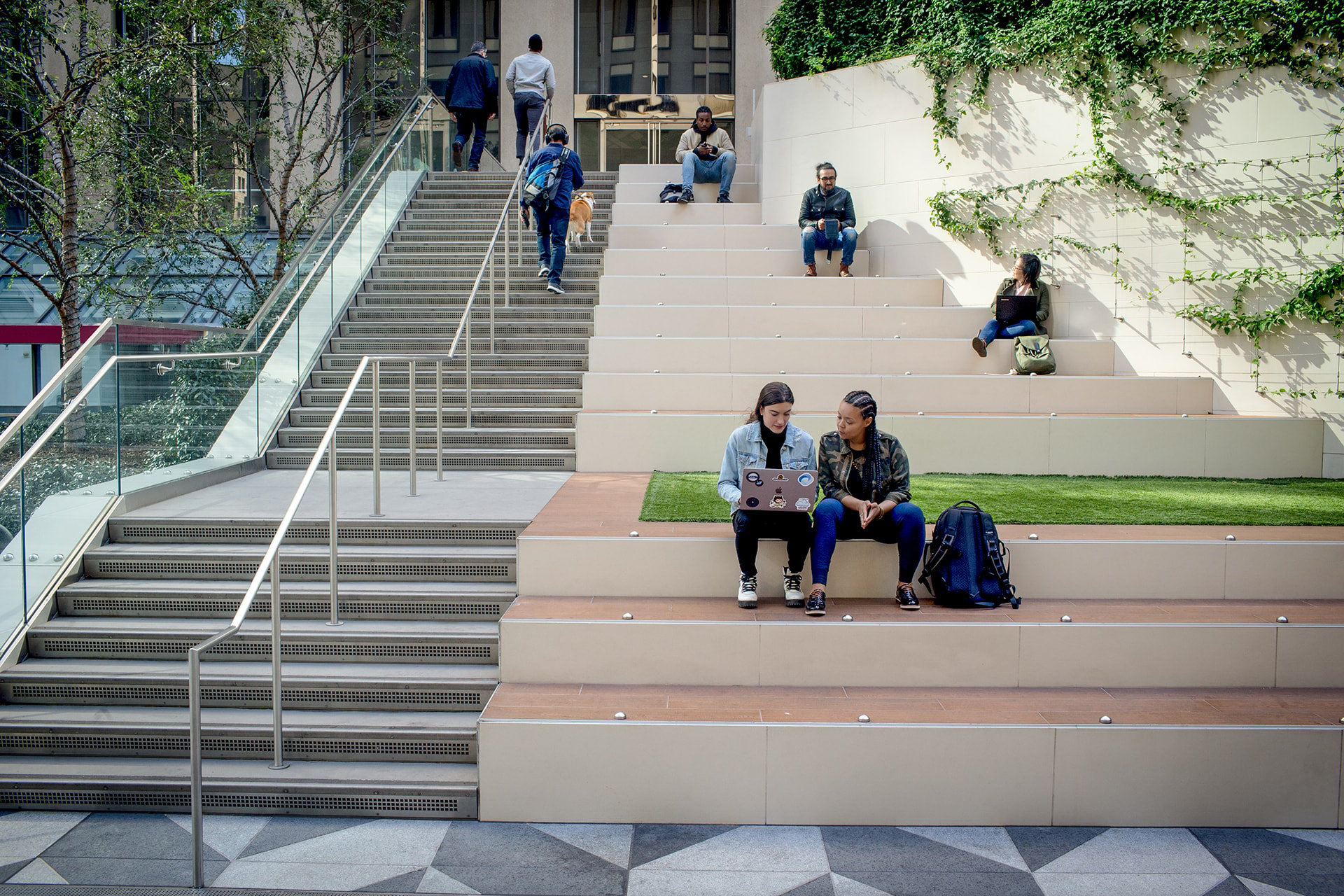 Two students looking at a laptop on campus.