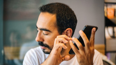 Visually impaired man using a smartphone.
