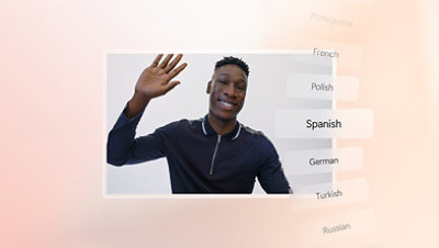 A smiling man waves alongside text which includes a selection of common international languages.