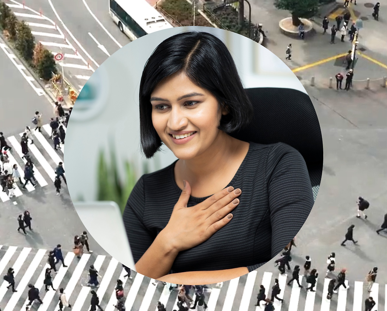 A woman holding her hand against her chest while working on her laptop, background image is set as road intersection with people passing by