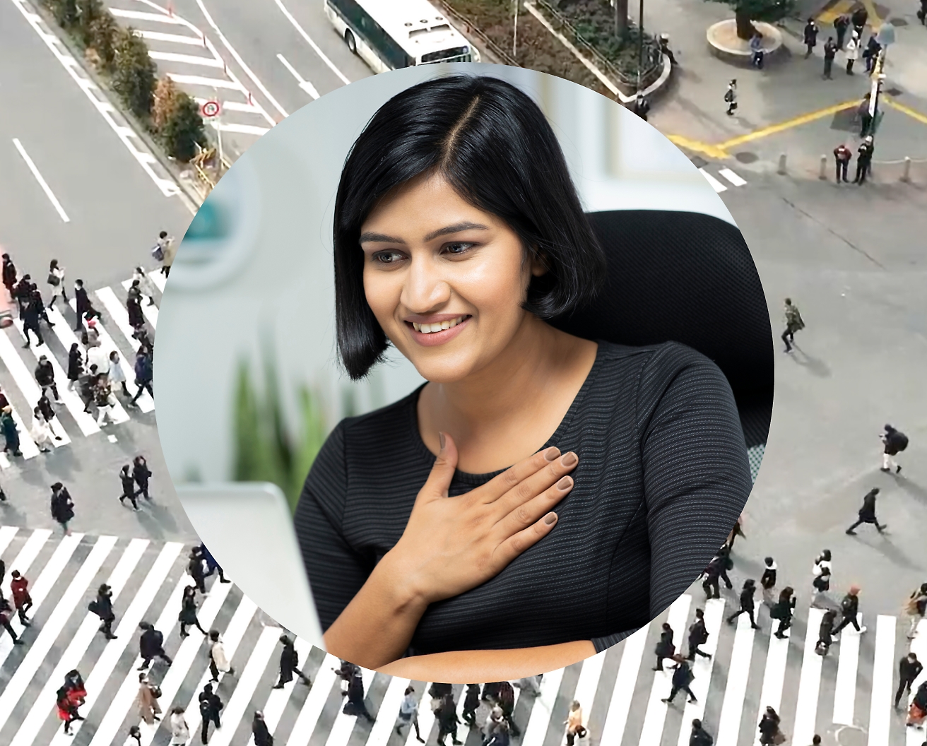 A woman holding her hand against her chest while working on her laptop, background image is set as road intersection with people passing by