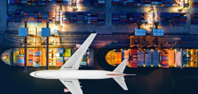 Image of a plane flying above the buildings