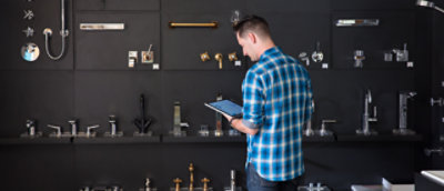 A person checking his tablet at a hardware store