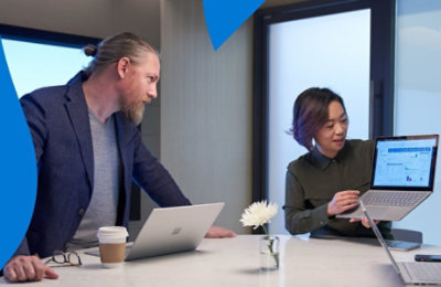A person presenting data to a colleague on a laptop.