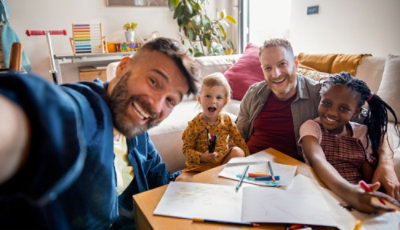 Una famiglia che sorride in una videochiamata.