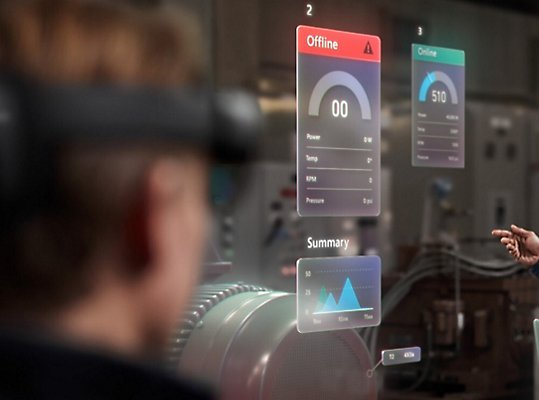 People wearing HoloLens devices to view data for machines in the room around them