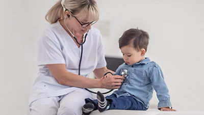 Nurse taking the heartbeat of a child
