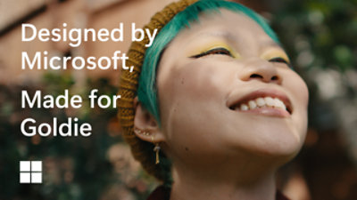 Person using a notebook next to a Surface laptop