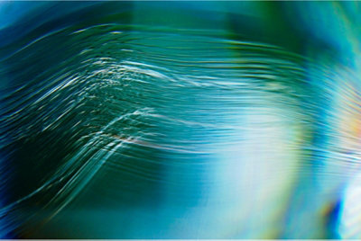Decorative: Abstract design with strands of light in blue and green.