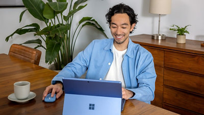 A person sitting on a couch using a laptop