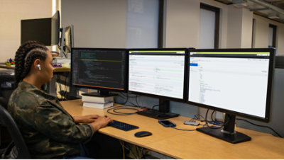A person sitting on the chair and working with computers