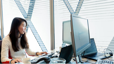 A person sitting in the office and working with computer