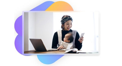 A person working on a laptop and mobile phone while taking care of a child.