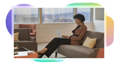 A person working at their desk with two monitors displaying Teams.