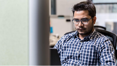 A man is sitting and working with laptop