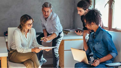 Four people talking in an office