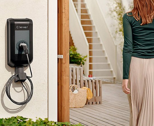 A person walking away from a Clever charging port.