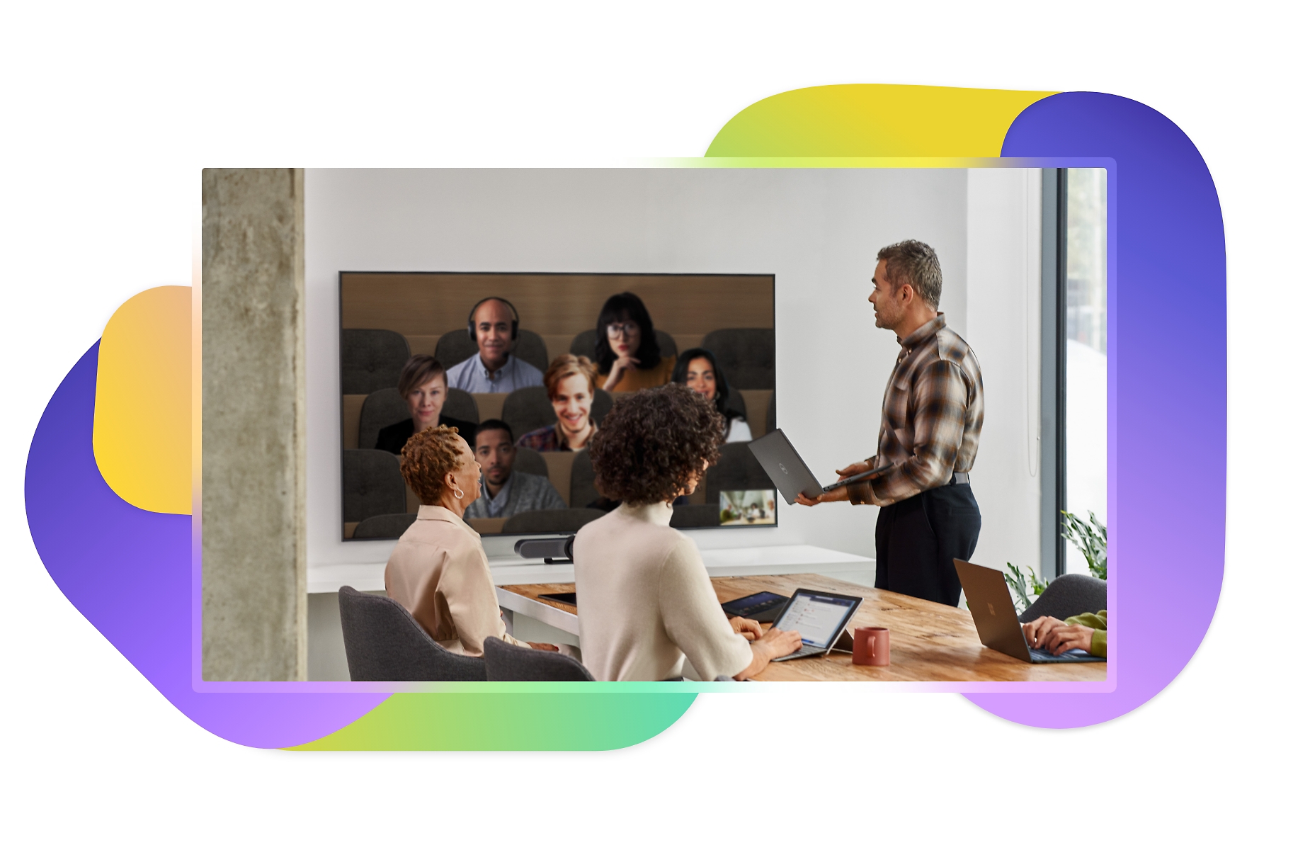 People in a conference room joining a Teams meeting in Together mode simulating auditorium seating
