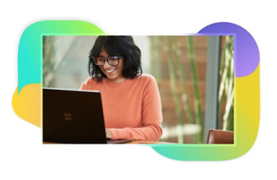 A person smiling and using a laptop