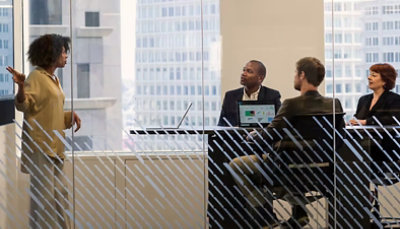 A group of people sitting around a table in a conference room.