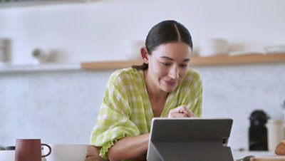 A person using a tablet resting on a kickstand