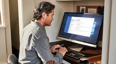A person working on their computer in a home office