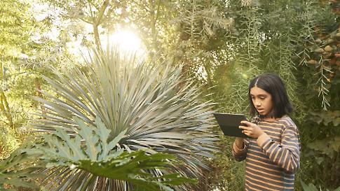 A child using a tablet outdoors.