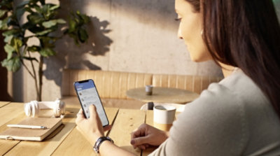 A person using Outlook on their mobile phone