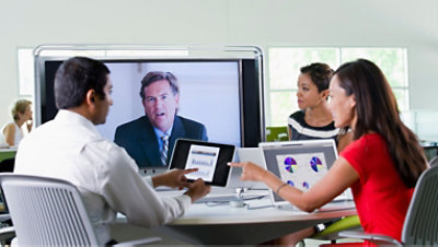 Multiple people using their laptops in a meeting